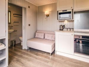 a small kitchen with a bench and a microwave at The Pod - Uk38513 in Babcary