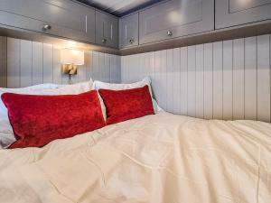 a large bed with two red pillows on it at The Pod - Uk38513 in Babcary