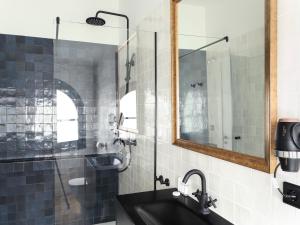 a bathroom with a sink and a mirror at Palacete Molina in Seville