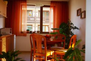 a kitchen with a table and chairs and a window at Nevena Apartments in Bansko