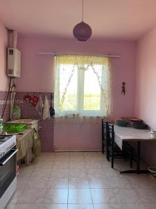 a kitchen with a window and a table with chairs at Rural Treasure in Garni