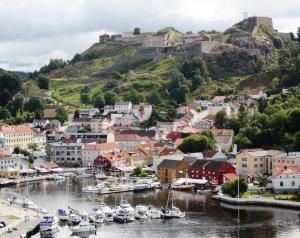 a town on a hill with boats in a harbor at Home Hotel Park in Halden