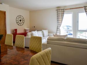 a living room with a couch and a table and chairs at Sandy Feet - Uk39822 in Portpatrick