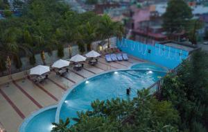 an overhead view of a swimming pool at a hotel at The Competent Palace Hotel in Jhājra