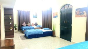 a bedroom with two beds in a room at GR Stays - 3Bhk Private Villa in Calangute with Private Jacuzzi Pool in Calangute