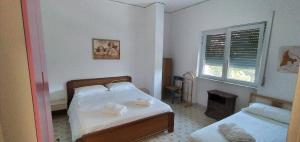 a bedroom with two beds and a window at VILLA VERDEMARE in Paestum +81 photos
