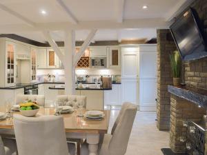 a kitchen and dining room with a table and chairs at Tennox House - Uk36254 in Kilbirnie