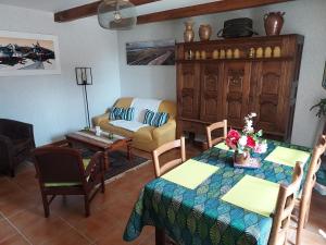 a living room with a table and a couch at Ty Kreiz in Saint-Ségal