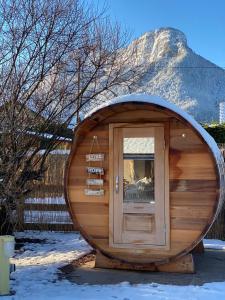 a circular building with a door in front of a mountain at Hygge Lodge Annecy in Doussard