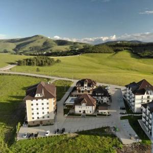 an aerial view of a house in a green field at Zlatibor Hills Royal in Zlatibor