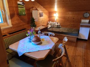 a dining room with a table with a cake on it at Ferienwohnungen Schneiderhäusl in Alpbach