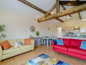 a living room with two couches and a kitchen at Courtyard Cottage - Uk39179 in Rossendale