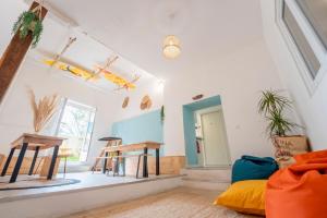a living room with a couch and a table at GARDEN - Utopy Hostel in Biarritz