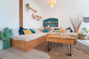 a room with a bed and a couch and a table at GARDEN - Utopy Hostel in Biarritz