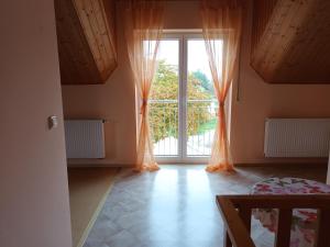 a room with a large window with orange curtains at Haus Barbara in Bad Füssing
