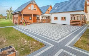 a house with a stone driveway in front of it at Nice Home In Rowy With Wifi in Rowy
