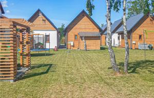 a yard with wooden houses and a playground at Nice Home In Rowy With Wifi in Rowy