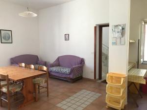 a living room with a table and a couch at Casa Vacanze in Santa Maria di Castellabate +13 photos