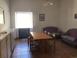 a living room with a table and chairs and a window at Casa Vacanze in Santa Maria di Castellabate