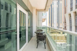 a balcony with a table and chairs on it at Dream Inn Apartments - Marina Pinnacle in Dubai