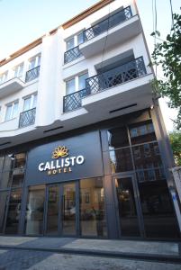 a building with a sign for a hotel at Hotel Callisto in Prishtinë