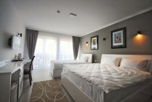 Postel nebo postele na pokoji v ubytování Hotel Callisto