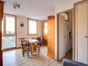 a kitchen and dining room with a table and chairs at Studio accueillant 4 pers., proche thermes, Luz-Saint-Sauveur - FR-1-402-74 in Luz-Saint-Sauveur +2 photos