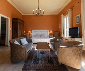 a bedroom with a bed and two chairs and a table at Castel Enchanté in Nice
