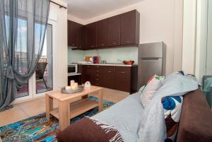 a kitchen with a couch and a table and a refrigerator at Anna's House in Kastoria