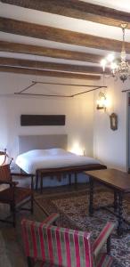a bedroom with a bed and a table and chairs at Chambre Renaissance au Château de Champagne-Mouton in Champagne-Mouton