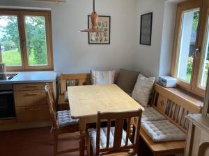 une cuisine avec une table et des chaises ainsi qu'une salle à manger dans l'établissement Ferienwohnung Schwarzindien, à Mondsee 10 autres photos