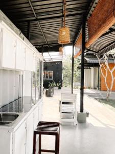 a kitchen with white cabinets and a table and chairs at Container Villa Collection in Kadawatha