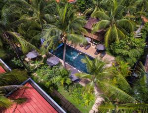 an aerial view of a resort with a swimming pool and palm trees at Apsara Greenland Boutique Villa & Resort in Siem Reap