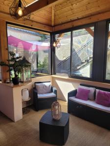 Sala de estar con 2 sofás y mesa en Les terrasses du Zinnkoepflé (8 à 12 personnes), en Westhalten