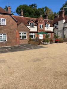 a large brick house with a driveway in front at The Old Dairy Steep,Petersfield in Collyers Estate in the South Downs National park in Petersfield