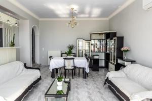 a living room with a table and a couch at Vigere Luxury Villa in Monolithos