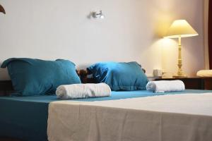 a blue bed with two towels on top of it at Sky Palace Beach Hotel in Trivandrum