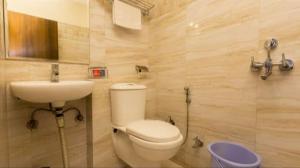 a bathroom with a toilet and a sink at Hotel R DELUXE "Couple Friendly Vaccinated Staff" in New Delhi