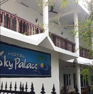 a hotel sly palace sign on the side of a building at Sky Palace Beach Hotel in Trivandrum
