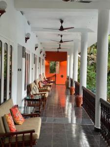 a hallway with couches and chairs in a building at Sky Palace Beach Hotel in Trivandrum