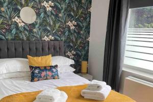 a bedroom with a bed with two towels on it at Cayton village hide away in Cayton