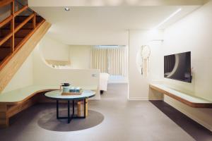 a room with a table and a staircase at Chu Resort Hualien in Fenglin