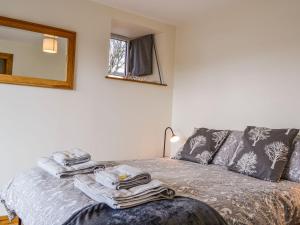 a bedroom with a bed with towels on it at The Old Mill in Fettercairn