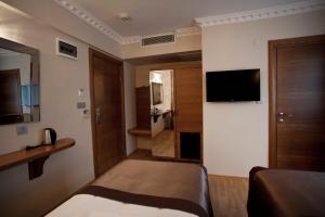 a hotel room with a bed and a television at Pera Line Hotel in Istanbul +58 photos