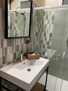 a bathroom with a sink and a shower at B&B La DORMERIA in Finale Ligure