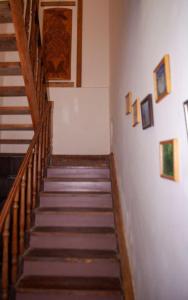 a set of stairs in a building with paintings on the wall at B&B Sunrise House Aygavan in Aygavan