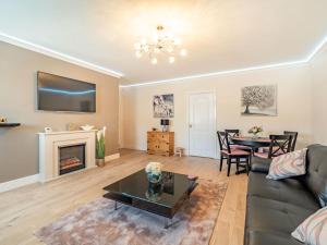 a living room with a couch and a fireplace at Squirrel Cottage - Uk37886 in Stanhope