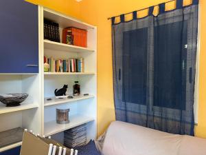 a room with a bed and a book shelf at Villa Green Place in Mascali