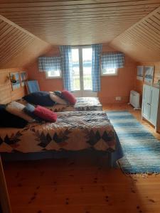 a woman laying on a bed in a room at Holiday Cottage Tiira in Raseborg