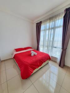 a bedroom with a red bed and a large window at Condo @ Bukit Indah/ Legoland/ Eco Botanic 6 pax in Gelang Patah